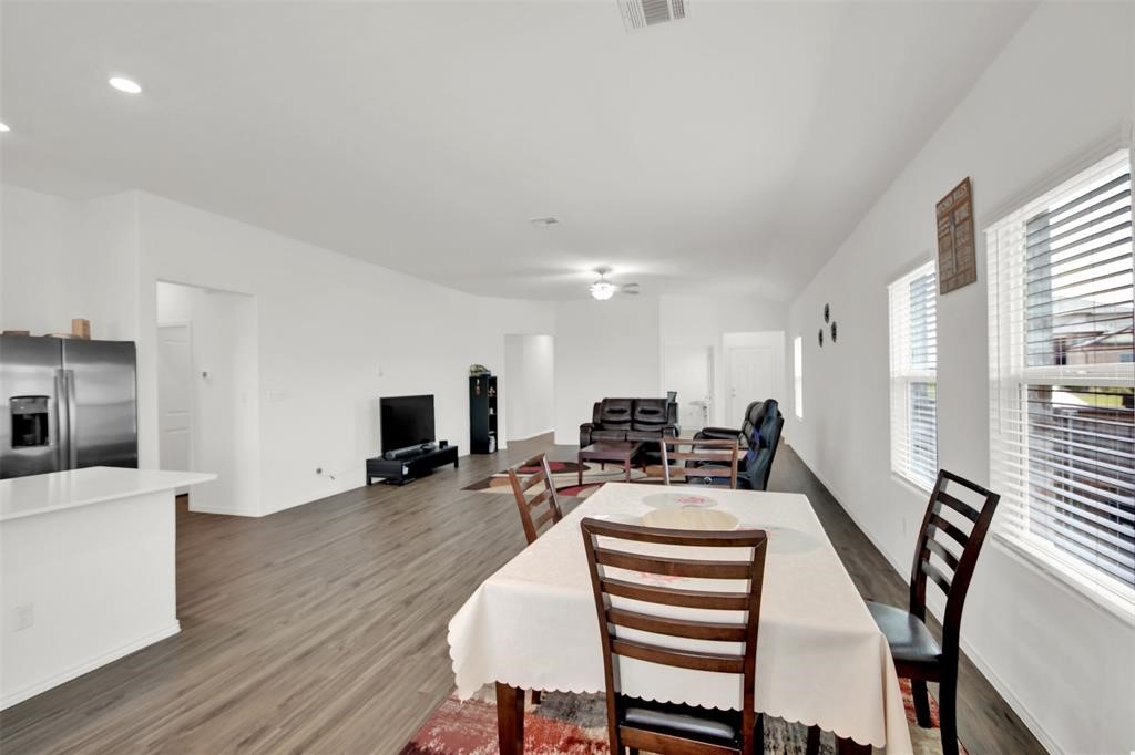 937 Mallow Road Leander, TX 78641 - Photo 14 of 30 a view of a dining room with furniture a fireplace and wooden floor