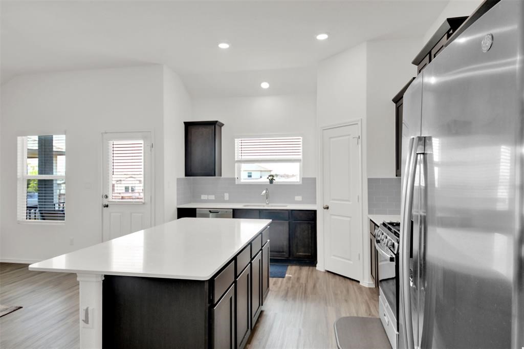 937 Mallow Road Leander, TX 78641 - Photo 15 of 30 a kitchen with a sink stainless steel appliances and refrigerator
