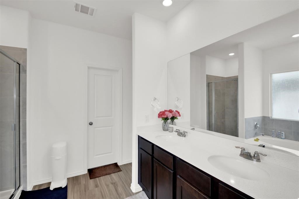 937 Mallow Road Leander, TX 78641 - Photo 17 of 30 a bathroom with a sink and a mirror