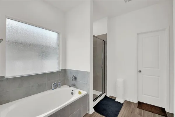 a bathroom with a tub and shower