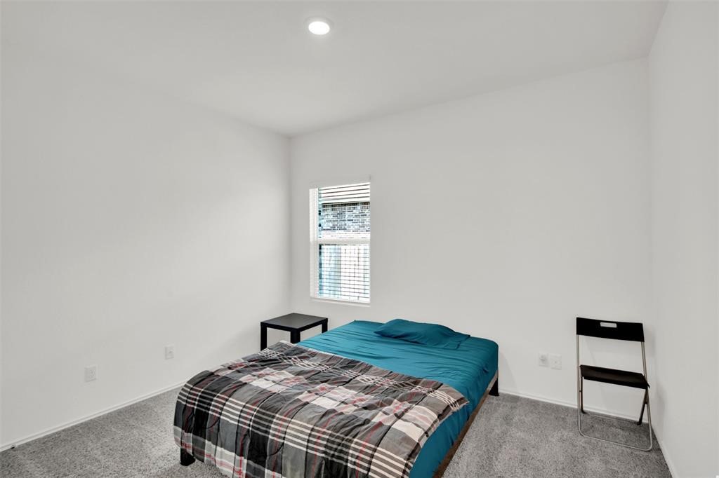 937 Mallow Road Leander, TX 78641 - Photo 22 of 30 a bedroom with a bed and a window