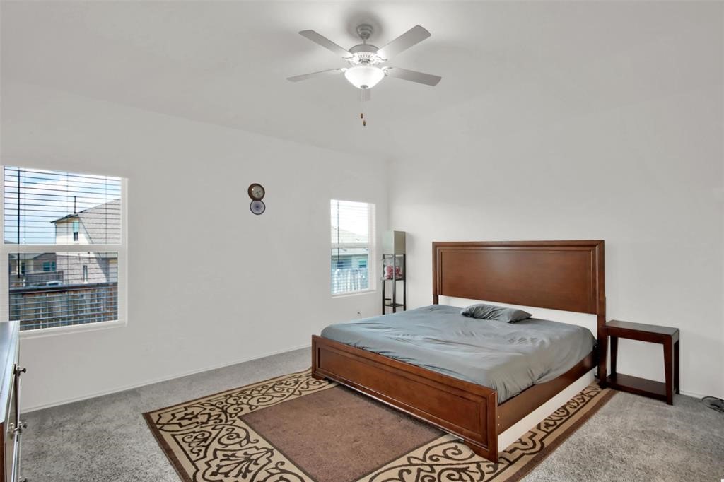 937 Mallow Road Leander, TX 78641 - Photo 24 of 30 a bedroom with a large bed and a window