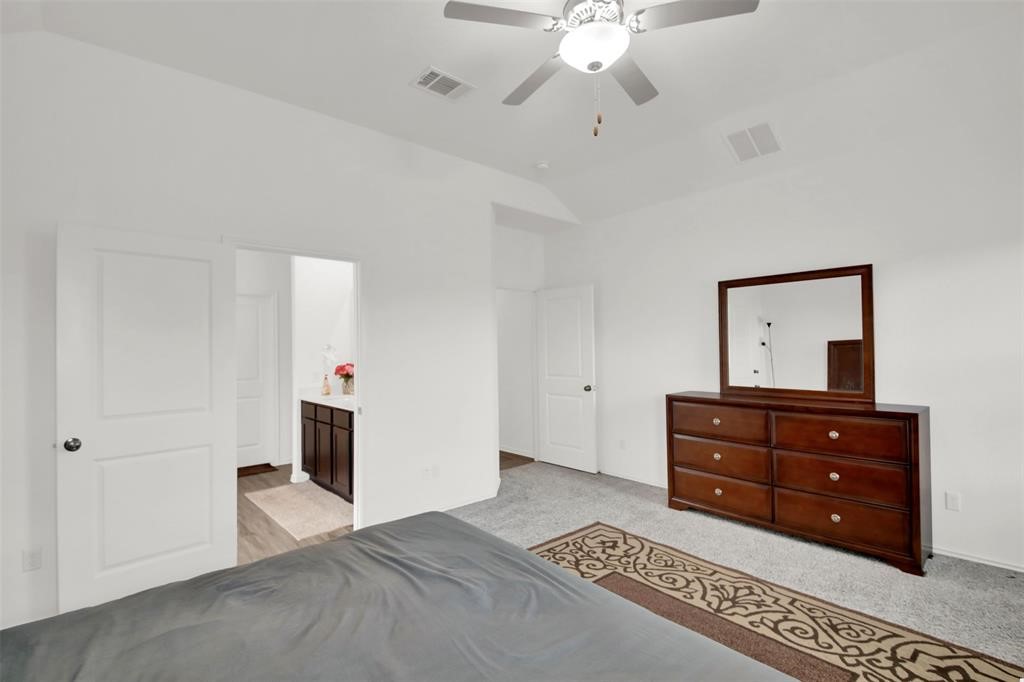 937 Mallow Road Leander, TX 78641 - Photo 26 of 30 a bedroom with a bed and a chandelier