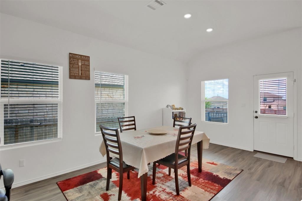 937 Mallow Road Leander, TX 78641 - Photo 28 of 30 a view of a dining room with furniture and wooden floor