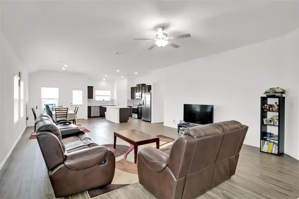 a living room with furniture a fireplace and a flat screen tv