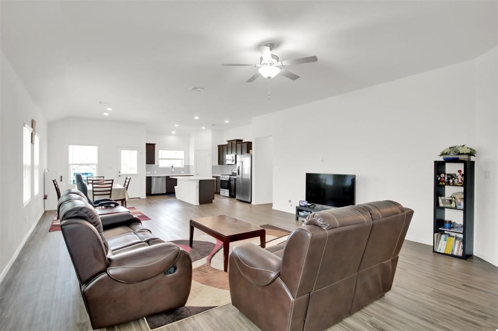 937 Mallow Road Leander, TX 78641 - Photo 9 of 30 a living room with furniture a fireplace and a flat screen tv