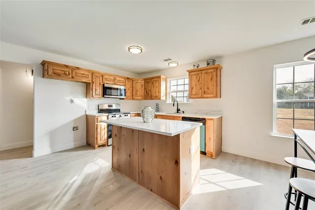 a kitchen with a sink stove and cabinets