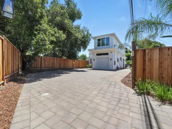 a house with a yard and wooden fence
