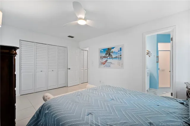 a view of a bedroom with wooden floor and cabinet