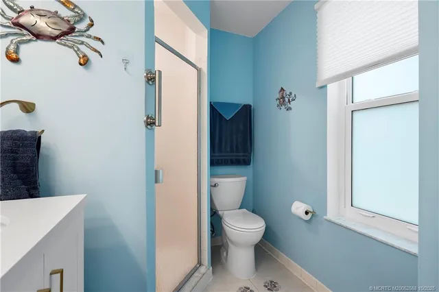 a white toilet sitting next to a bathroom sink