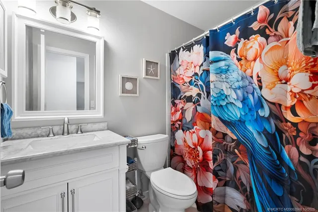 a bathroom with a sink and mirror with toilet