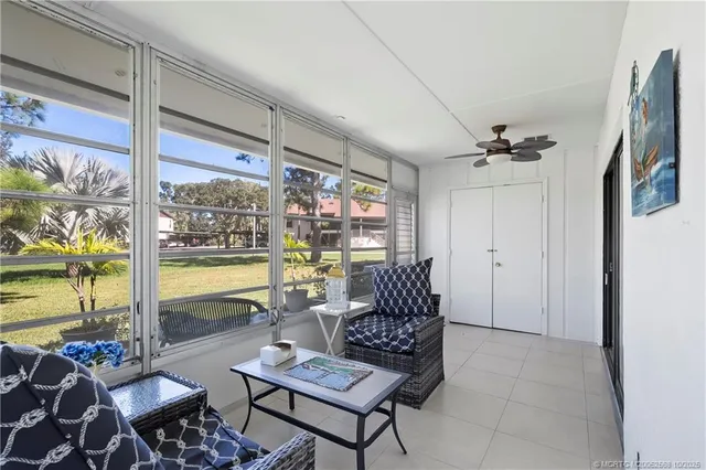 a living room with furniture and a floor to ceiling window