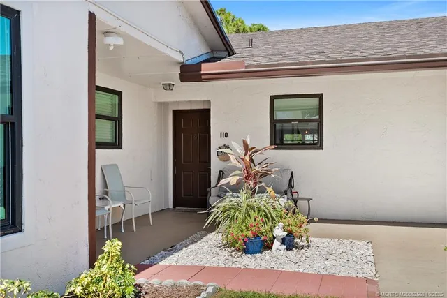 a view of house with backyard and outdoor seating