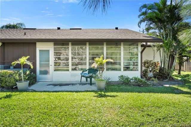 an aerial view of residential houses with outdoor space and river