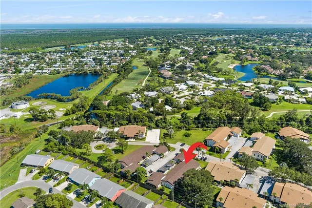 an aerial view of residential houses with outdoor space