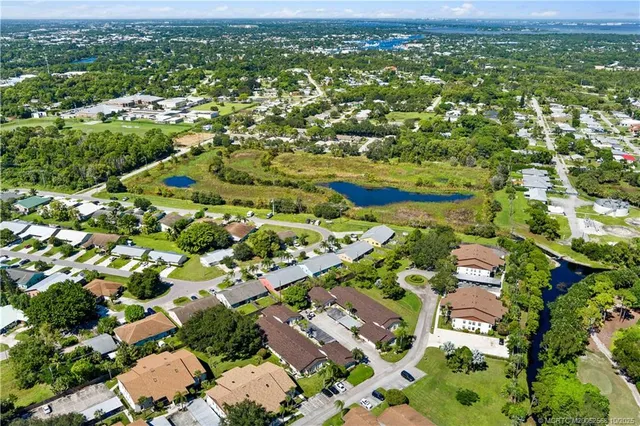 an aerial view of residential houses with outdoor space