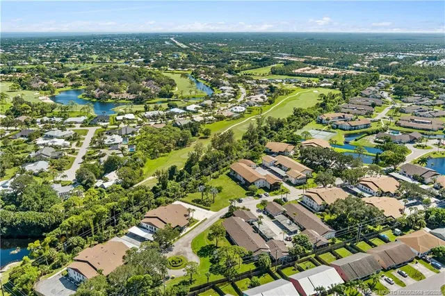 an aerial view of a house with a garden and a yard