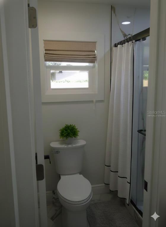 820 Dove Ridge Drive Lakeland, FL 33803 - Photo 16 of 21 a white toilet sitting in a bathroom next to a window