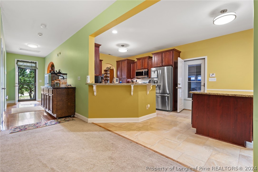 5078 Aberdeen Road Raeford, NC 28376 - Photo 11 of 46 a view of a kitchen with a refrigerator a microwave and a sink
