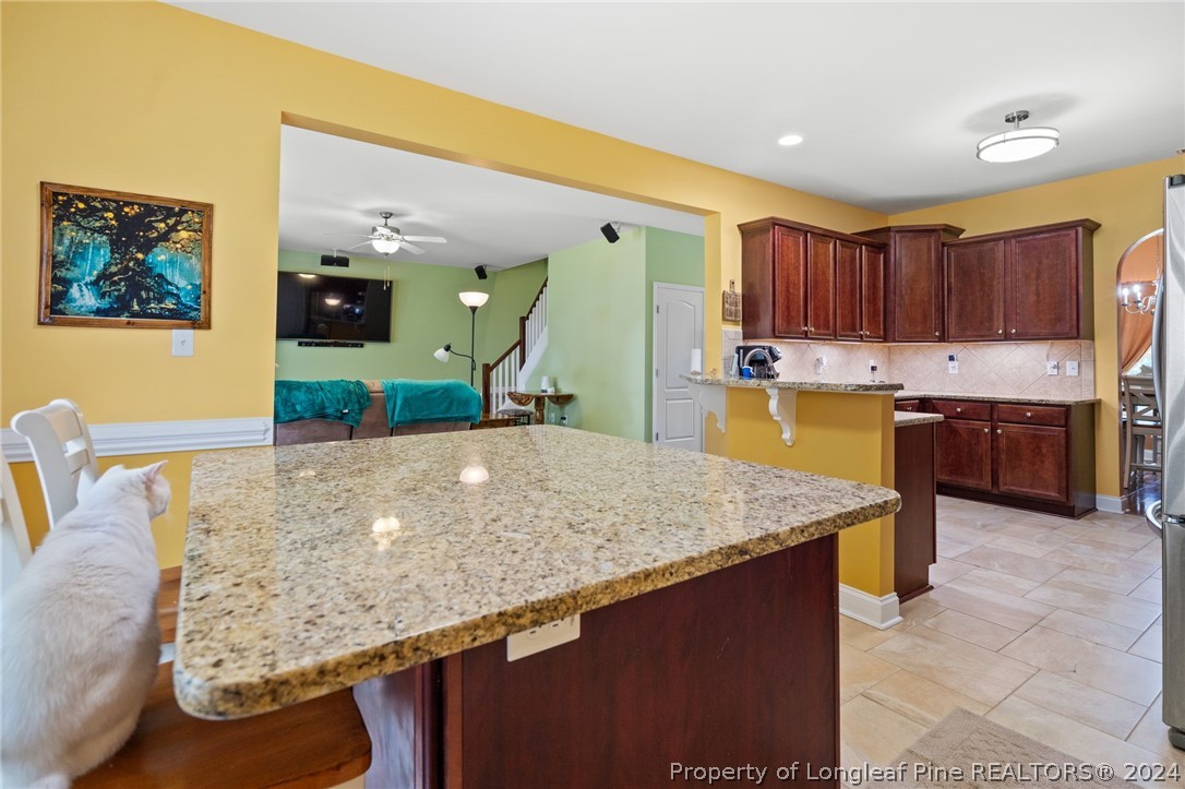 5078 Aberdeen Road Raeford, NC 28376 - Photo 14 of 46 a kitchen with kitchen island a sink a counter top space and stainless steel appliances