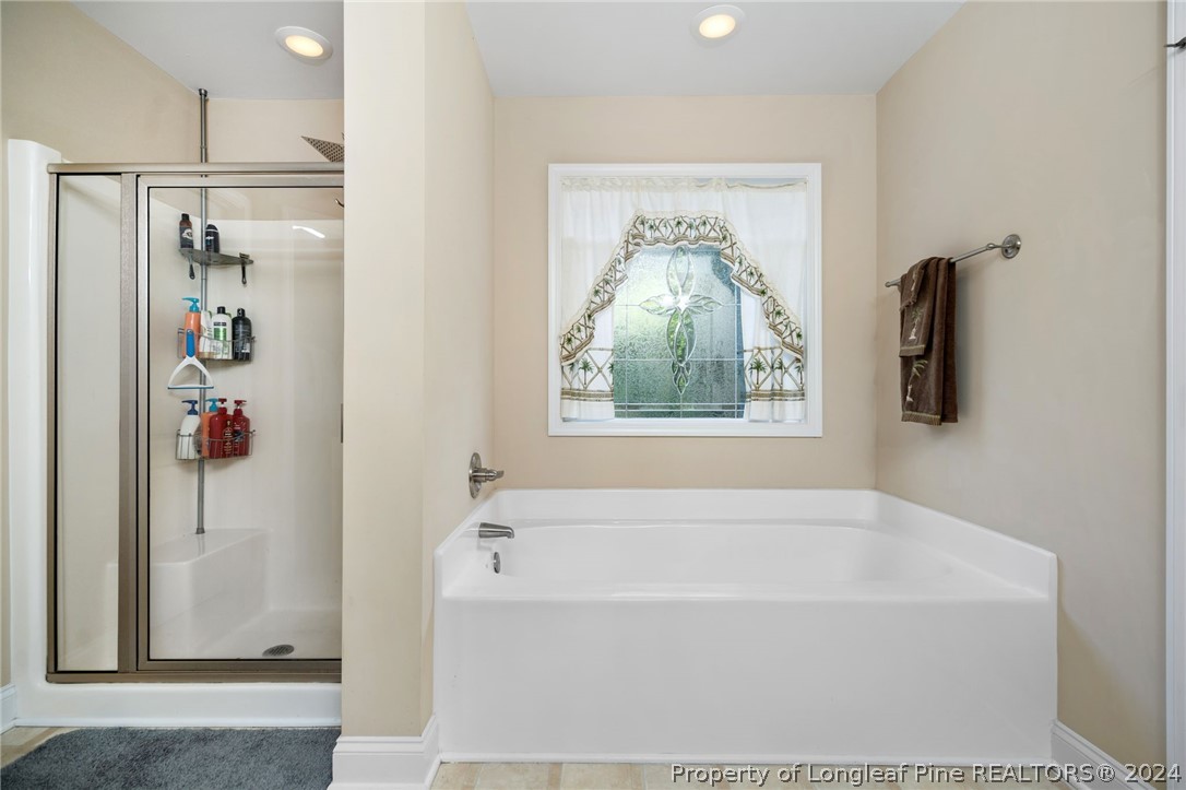 5078 Aberdeen Road Raeford, NC 28376 - Photo 24 of 46 a bathroom with bathtub and window