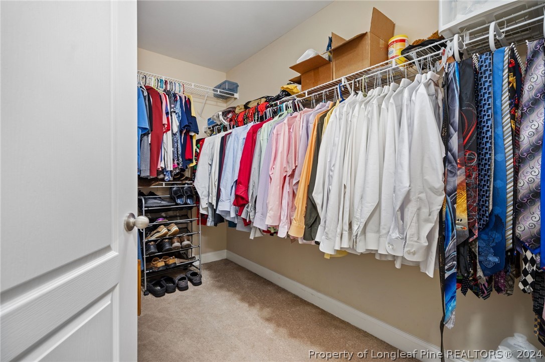 5078 Aberdeen Road Raeford, NC 28376 - Photo 25 of 46 a view of walk in closet with clothes