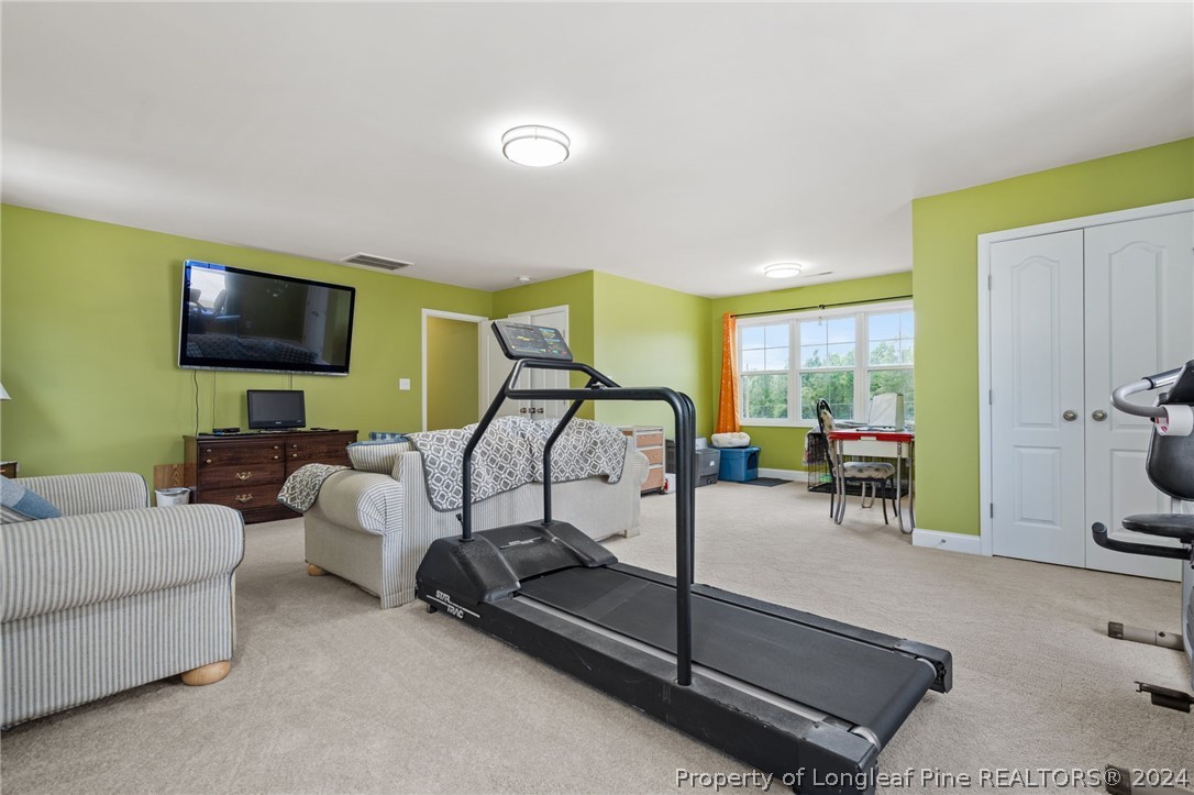 5078 Aberdeen Road Raeford, NC 28376 - Photo 27 of 46 a bedroom with furniture and a flat screen tv
