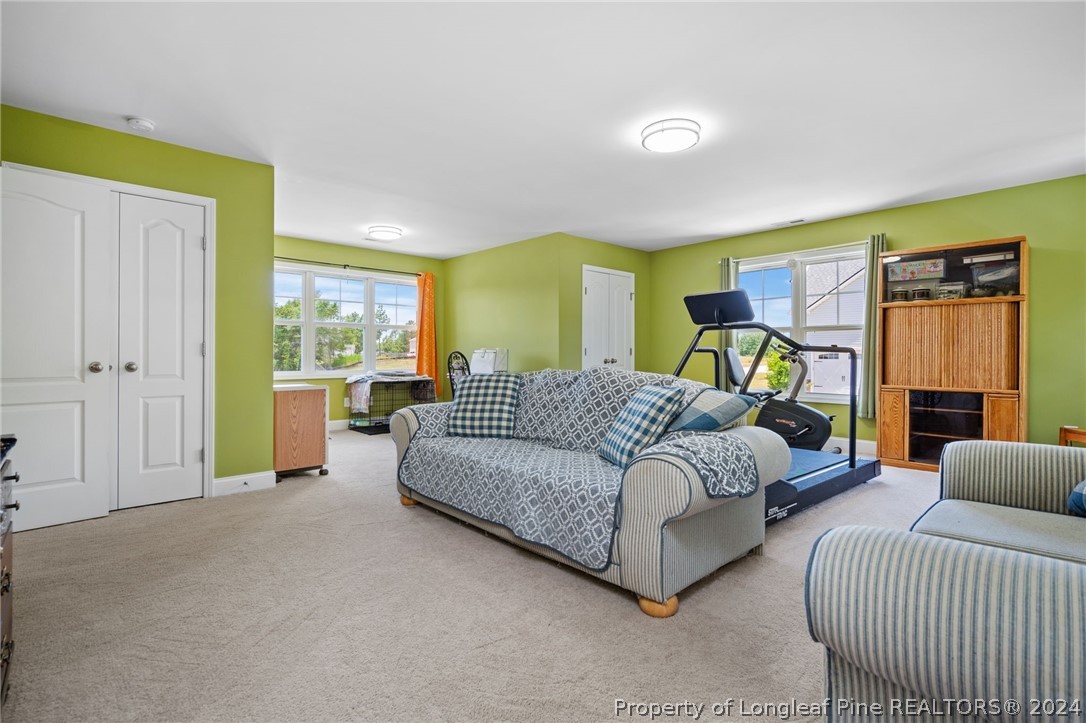 5078 Aberdeen Road Raeford, NC 28376 - Photo 29 of 46 a spacious bedroom with a bed and a couch