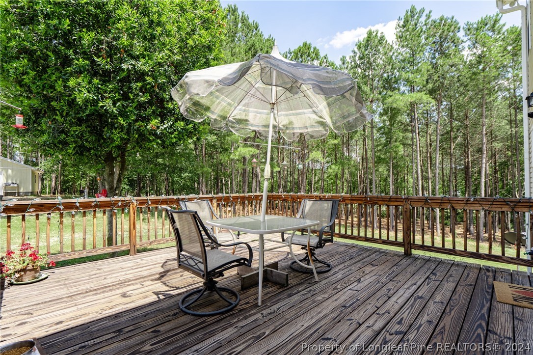 5078 Aberdeen Road Raeford, NC 28376 - Photo 40 of 46 a view of a deck with furniture and umbrella