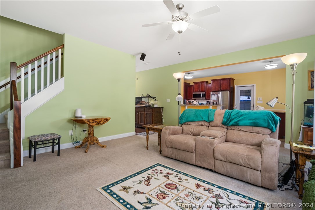 5078 Aberdeen Road Raeford, NC 28376 - Photo 7 of 46 a living room with furniture and a chandelier