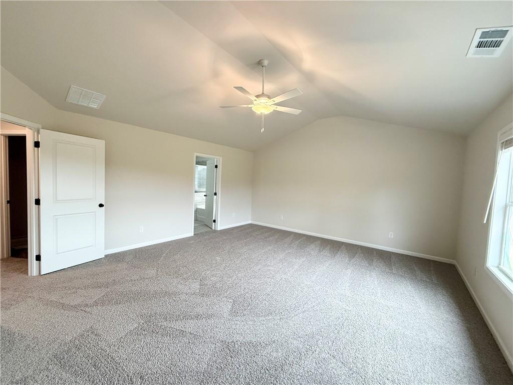 2506 Sunny Hill Road Buford, GA 30519 - Photo 15 of 25 an empty room with a ceiling fan and a window