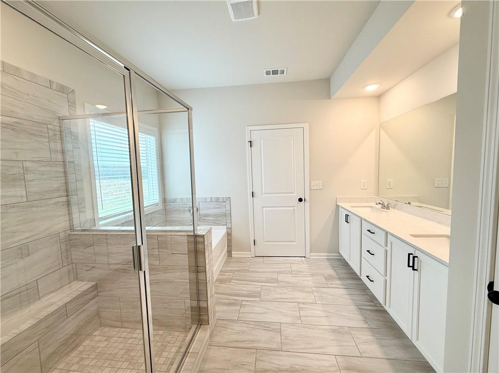 2506 Sunny Hill Road Buford, GA 30519 - Photo 16 of 25 a bathroom with a double vanity sink and a mirror