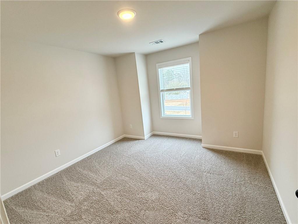 2506 Sunny Hill Road Buford, GA 30519 - Photo 20 of 25 an empty room with windows