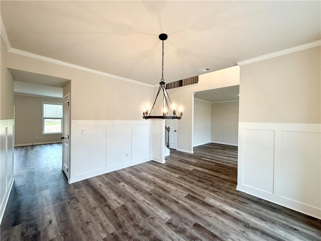 2506 Sunny Hill Road Buford, GA 30519 - Photo 6 of 25 a view of a room with wooden floor staircase and a living room