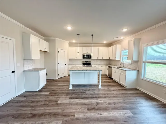 a kitchen with a refrigerator and cabinets