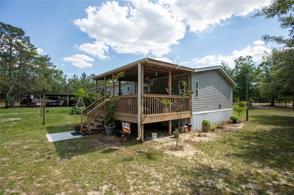 5670 Acadia Street Keystone Heights, FL 32656 - Photo 20 of 65 a view of a house with a yard