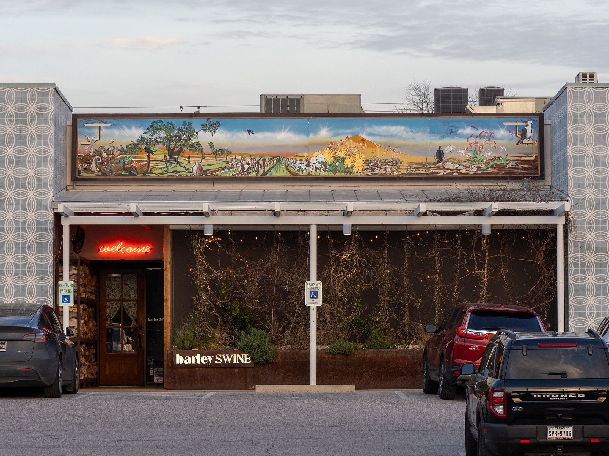 6444 Burnet Road, Unit 509 Austin, TX 78757 - Photo 26 of 32 An inviting restaurant facade with a vibrant mural, beckoning guests to an engaging dining experience.
