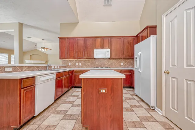 a kitchen with stainless steel appliances a sink and a refrigerator