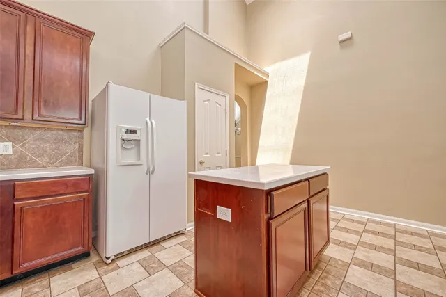 a kitchen with stainless steel appliances granite countertop a refrigerator a sink and dishwasher
