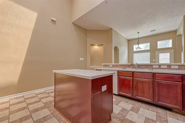 a spacious bathroom with a granite countertop sink and a mirror