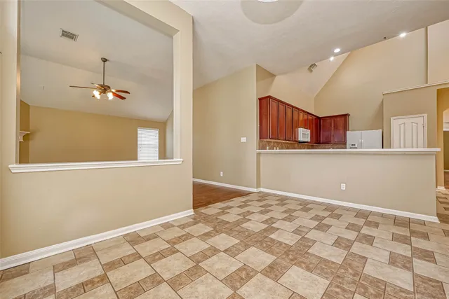 a view of a kitchen with wooden cabinet and a window