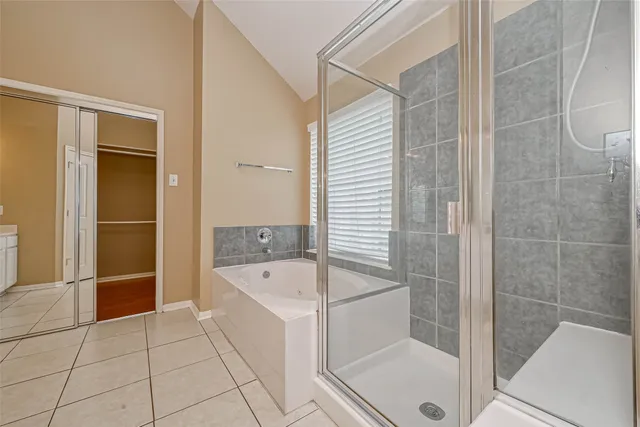 a bathroom with a bathtub and a shower