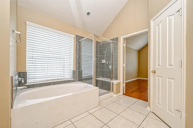 a spacious bathroom with a tub and shower