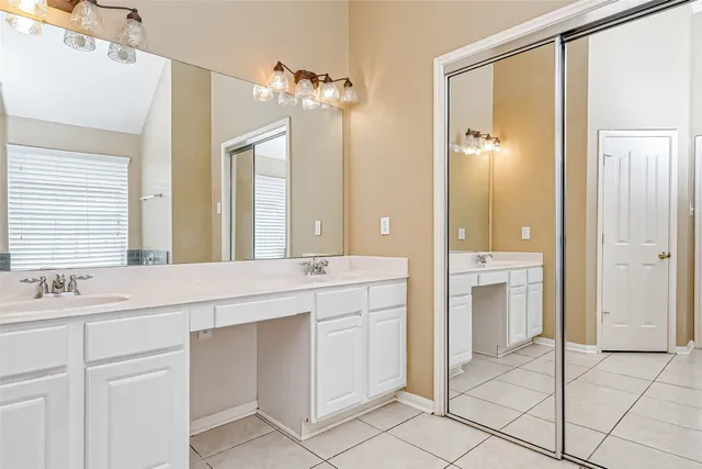 a spacious bathroom with a shower sink and mirror