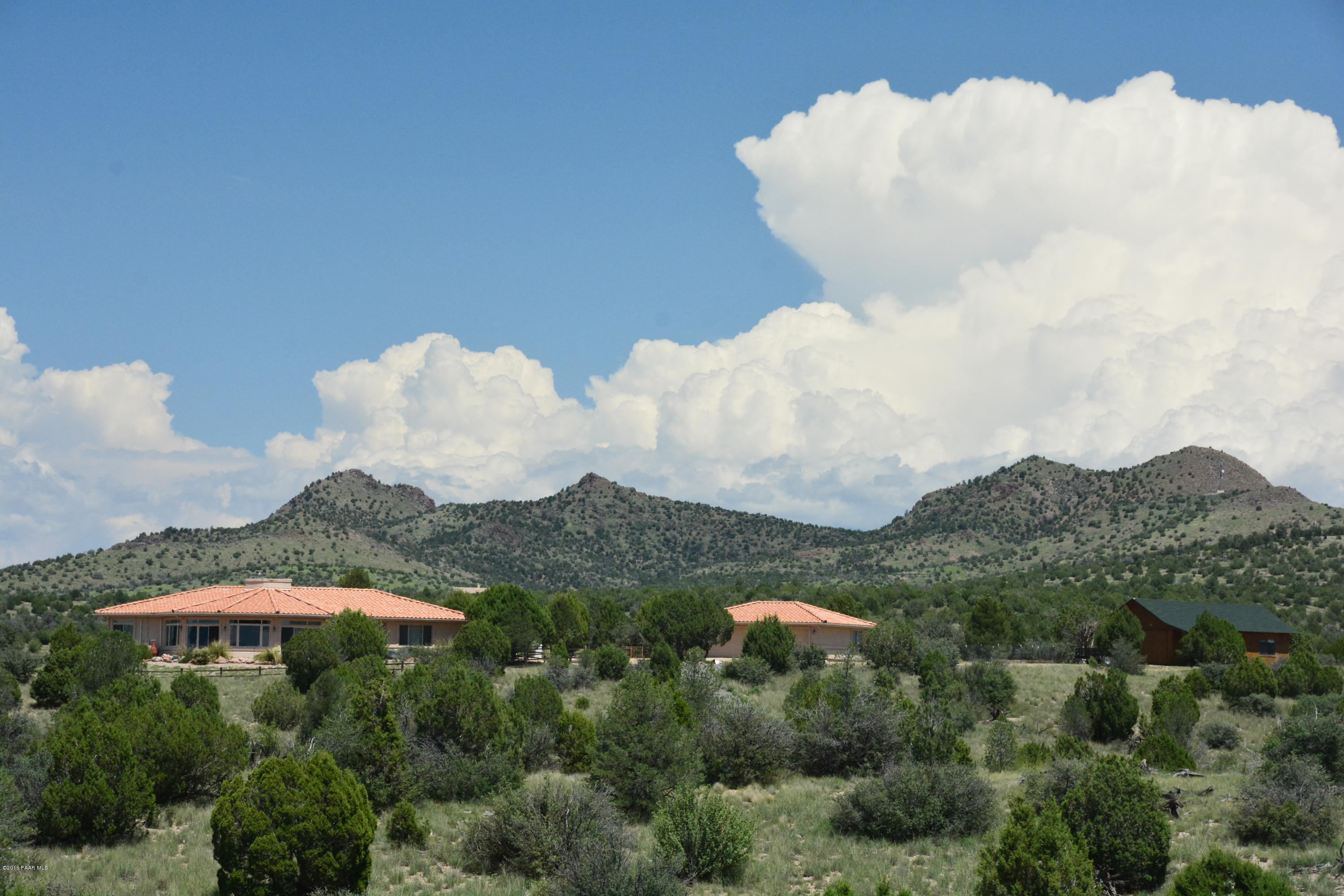 7200 Dillon Wash Road Prescott, AZ 86305 - Photo 1 of 47 a view of a house with a backyard and a lake view