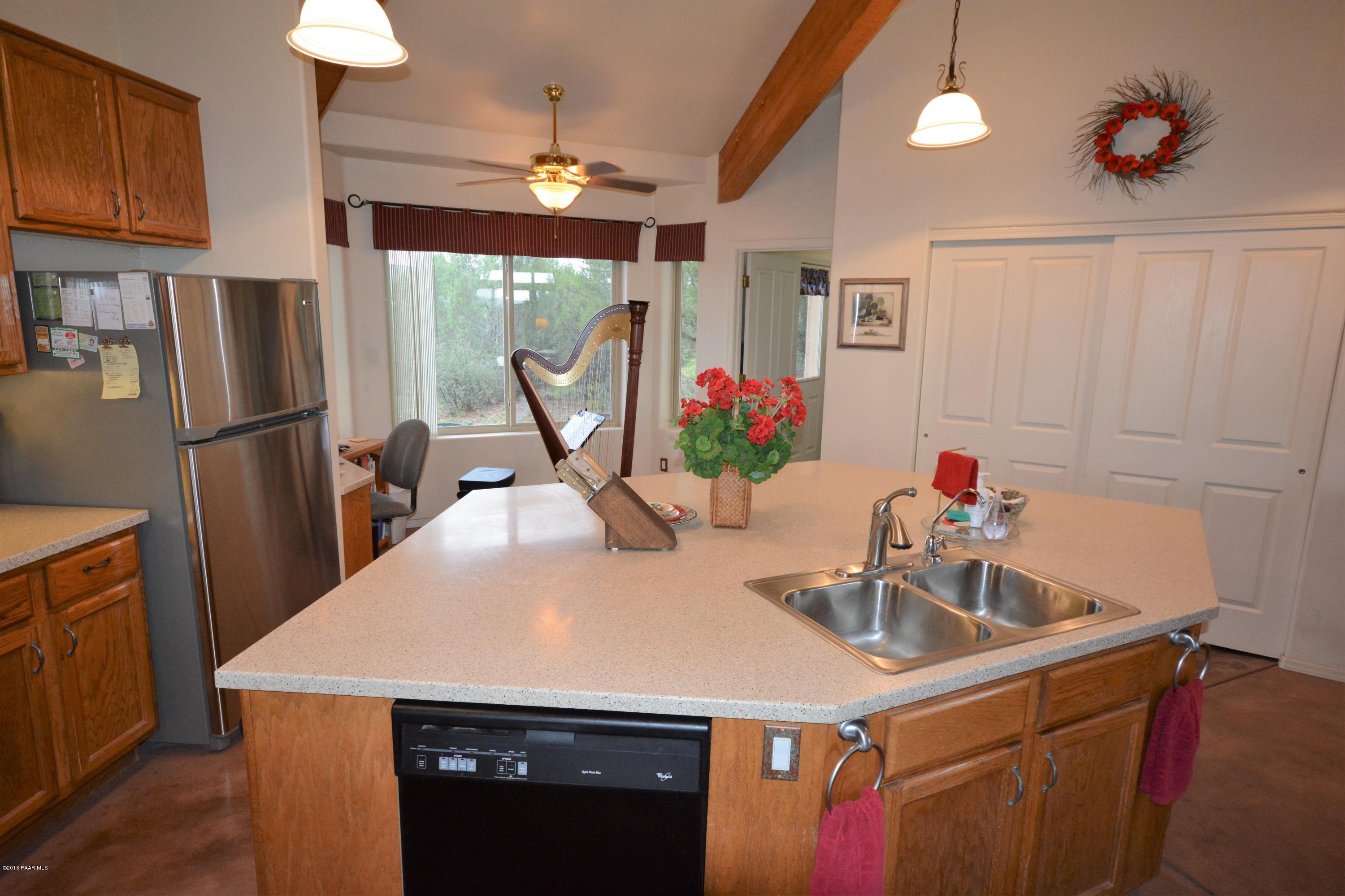 7200 Dillon Wash Road Prescott, AZ 86305 - Photo 19 of 47 a kitchen with a sink a refrigerator and a chandelier