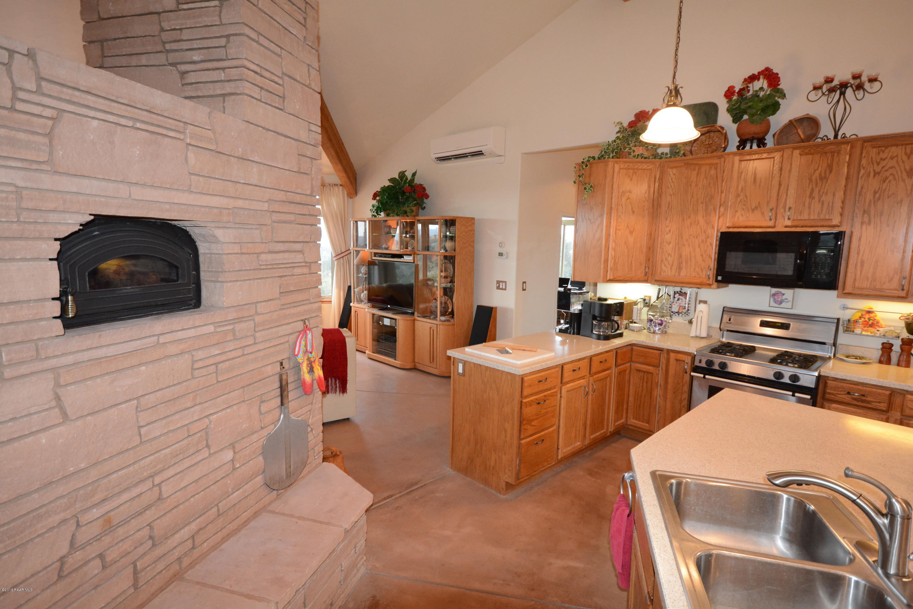 7200 Dillon Wash Road Prescott, AZ 86305 - Photo 21 of 47 a living room with furniture a flat screen tv and kitchen view
