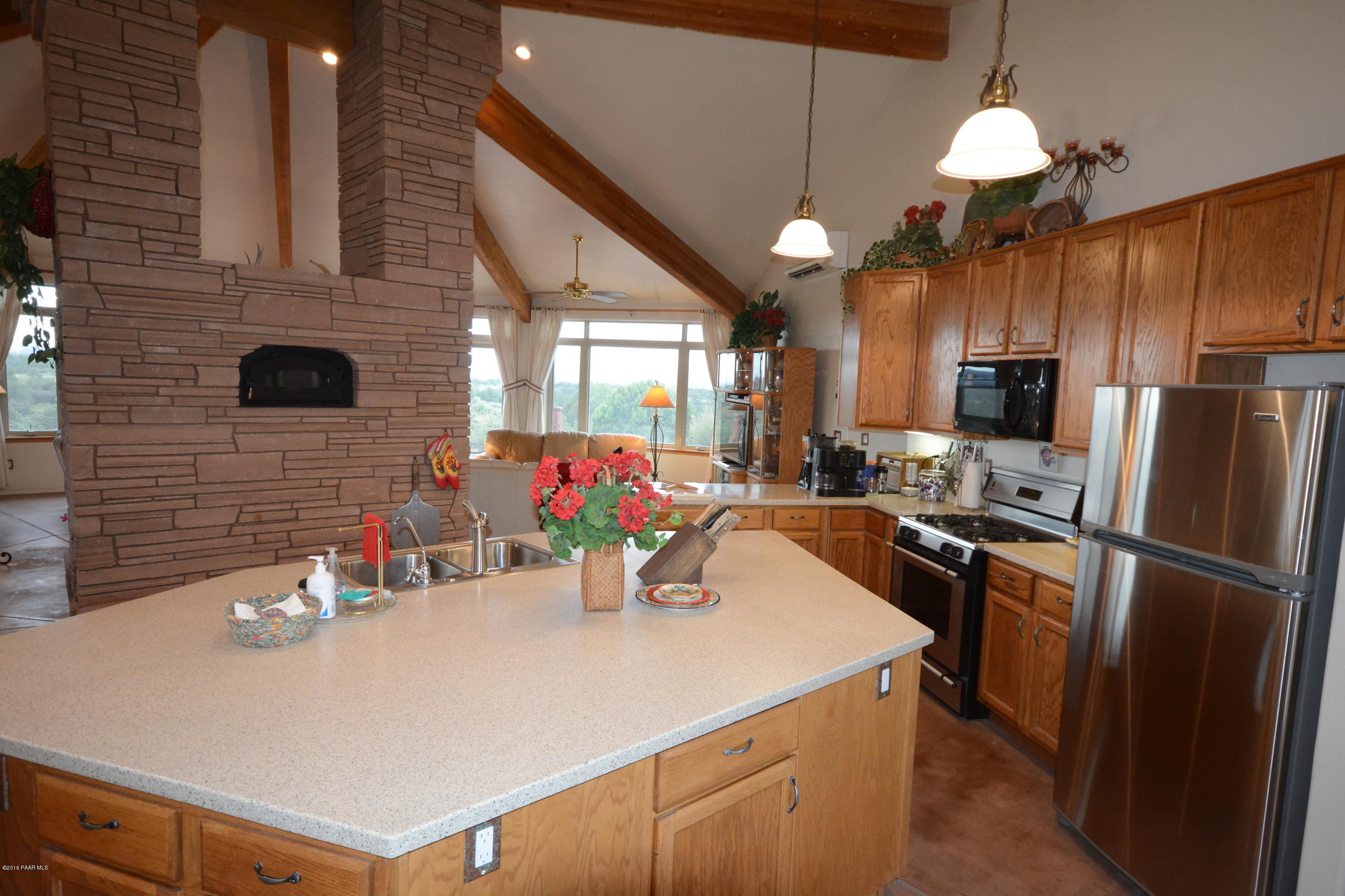 7200 Dillon Wash Road Prescott, AZ 86305 - Photo 22 of 47 a kitchen with a refrigerator a sink dishwasher a oven with a dining table and chairs