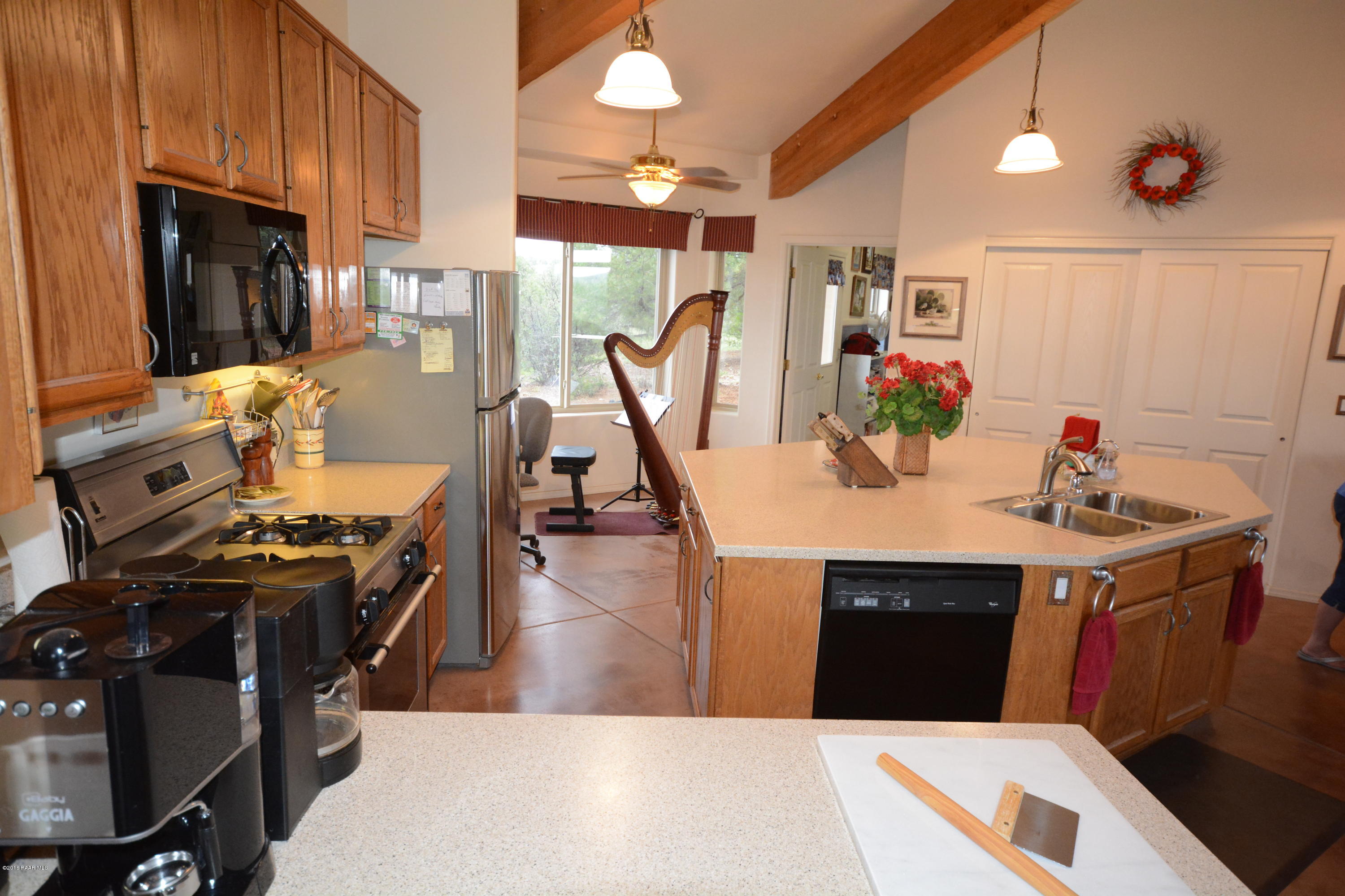 7200 Dillon Wash Road Prescott, AZ 86305 - Photo 23 of 47 a view of a kitchen with kitchen island stainless steel appliances wooden floor dining table and chairs