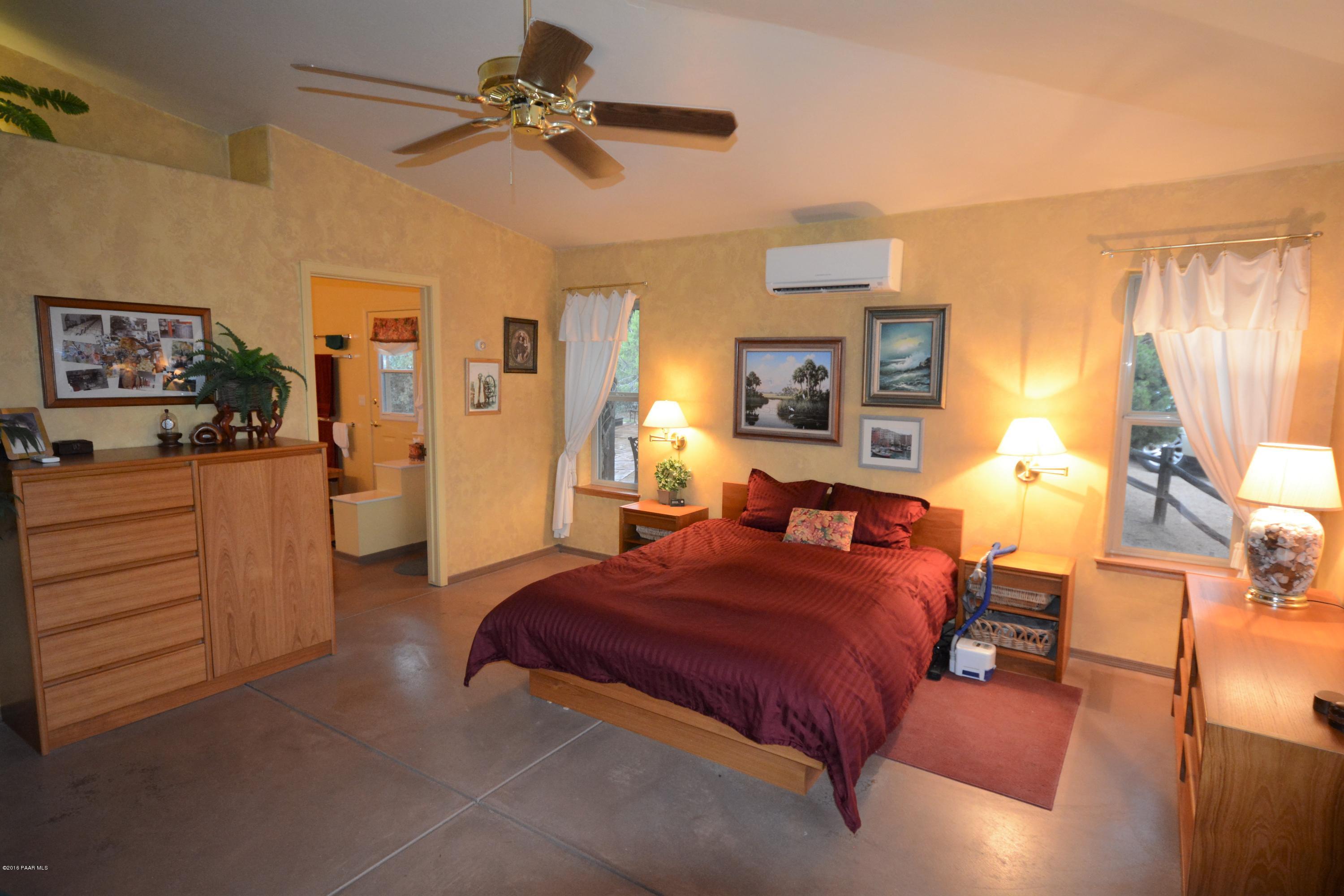 7200 Dillon Wash Road Prescott, AZ 86305 - Photo 25 of 47 a bedroom with furniture and a chandelier